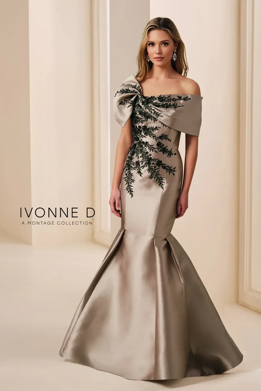 model is wearing an off the shoulder gold and black evening gown