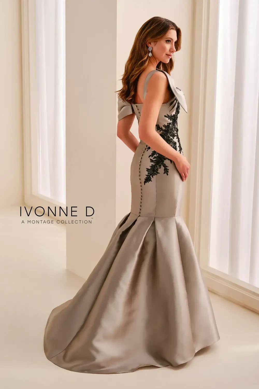 model is wearing an off the shoulder gold and black evening gown